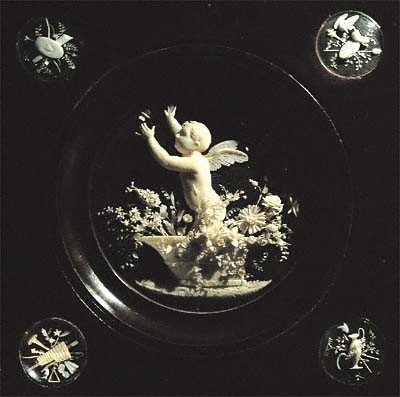 Putti Snatching a Butterfly, Standing in a Crater Vase of a Bouquet of Flowers, ivory micro carving, diameter of roundel 7cm, length of the plastic chamber frame is 12 cm